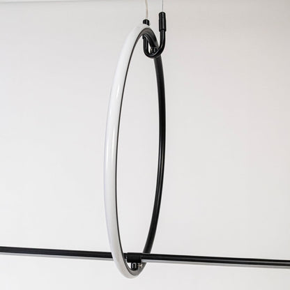 Closeup of slim black linear pendant light showing minimalist rod design and refined modern details.