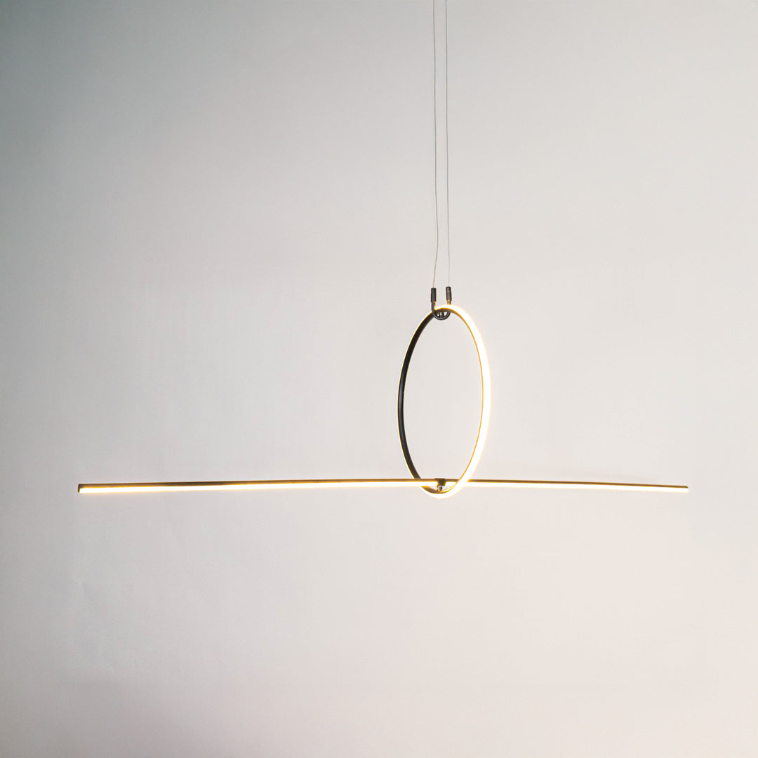 Gold metal linear LED pendant light with circular ring accent designed for sleek contemporary ceiling lighting indoors.