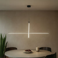 Slim black linear pendant light creating modern ambient lighting in a contemporary interior setting.