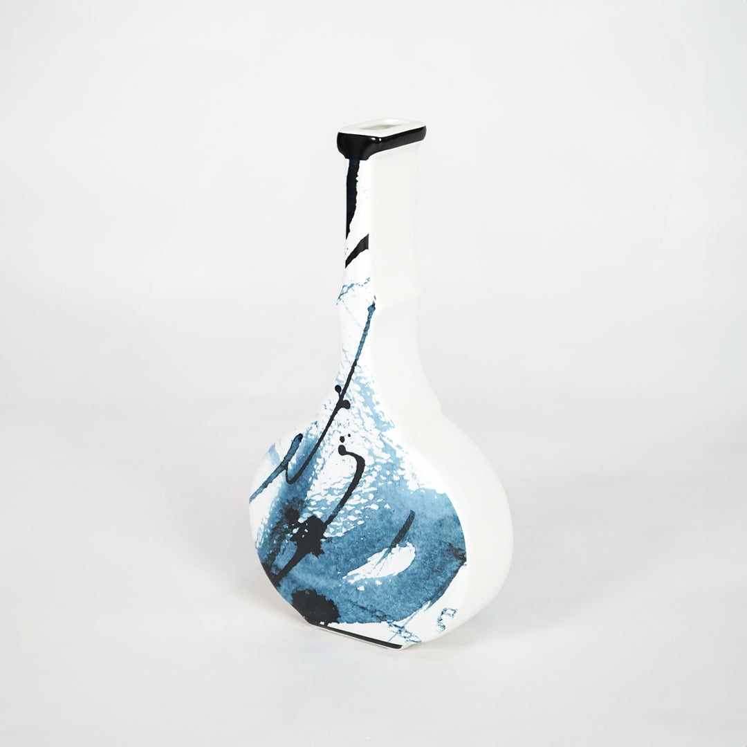 Blue and white ceramic bottle vase for elegant shelf placement and contemporary living room decor styling accent.