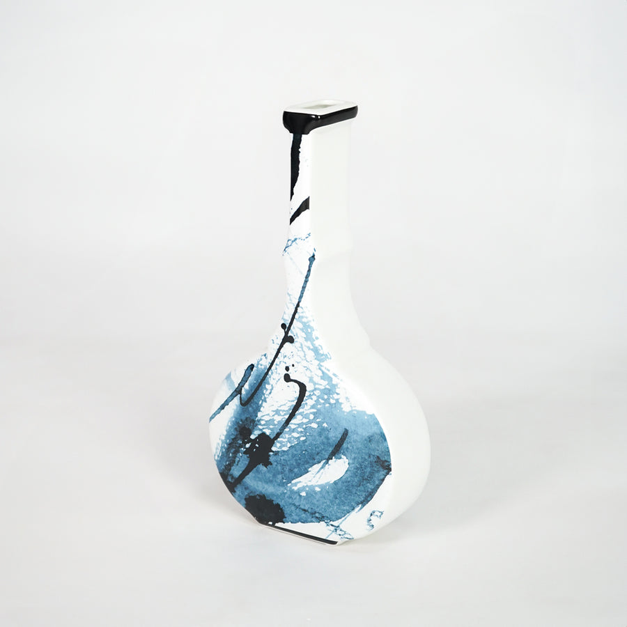 Blue and white ceramic bottle vase for elegant shelf placement and contemporary living room decor styling accent.