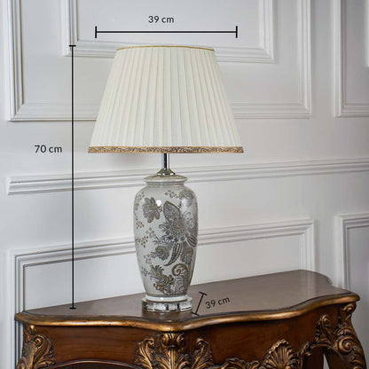 Ceramic table lamp with floral detailing shown with dimensions of 70 cm height and 39 cm shade width providing accurate sizing for placement.