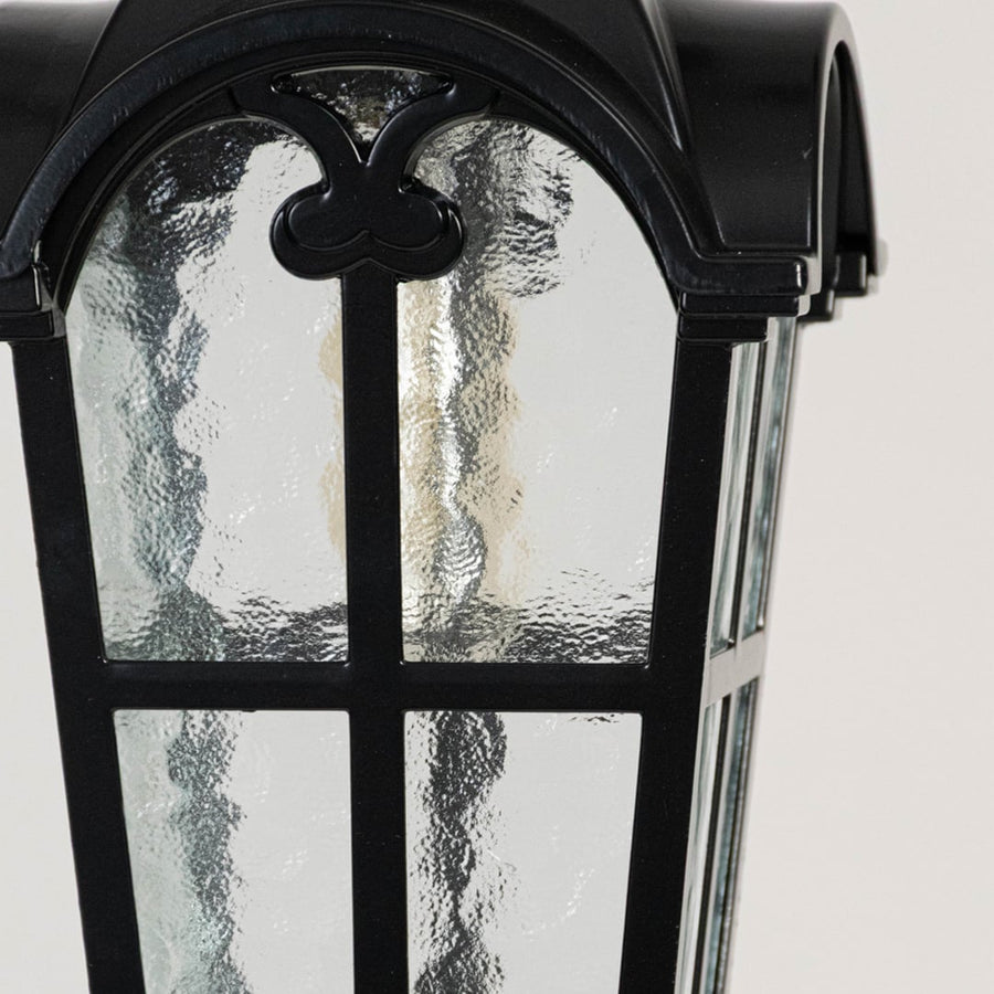 Detailed view of hanging lantern showing curved top design and frosted glass texture.