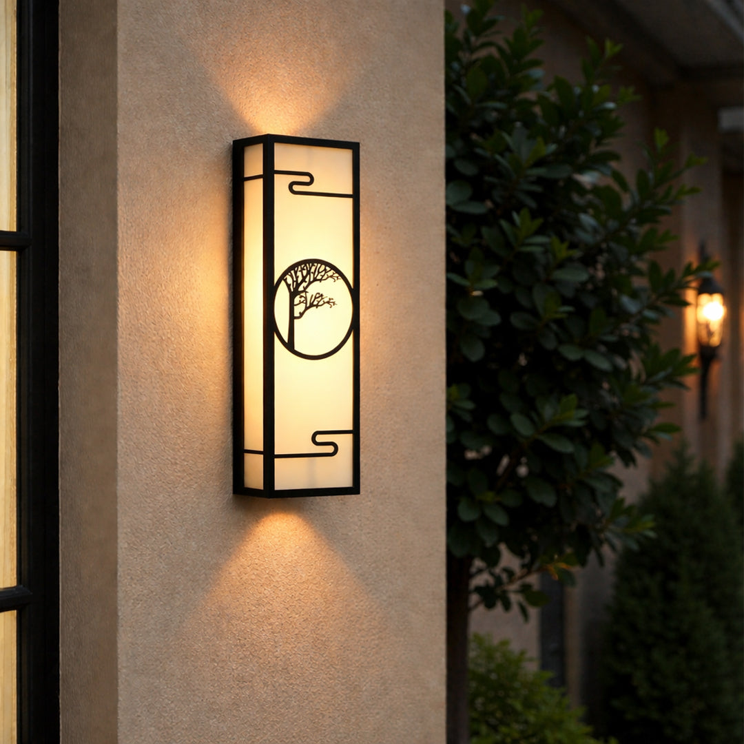 Decorative outdoor wall light with geometric frame and circular pattern mounted on exterior wall creating warm ambient lighting.