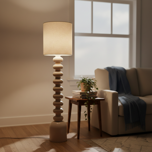 Lifestyle scene showing modern black floor lamp beside cozy armchair and side table near window adding warm ambient glow to living room decor.