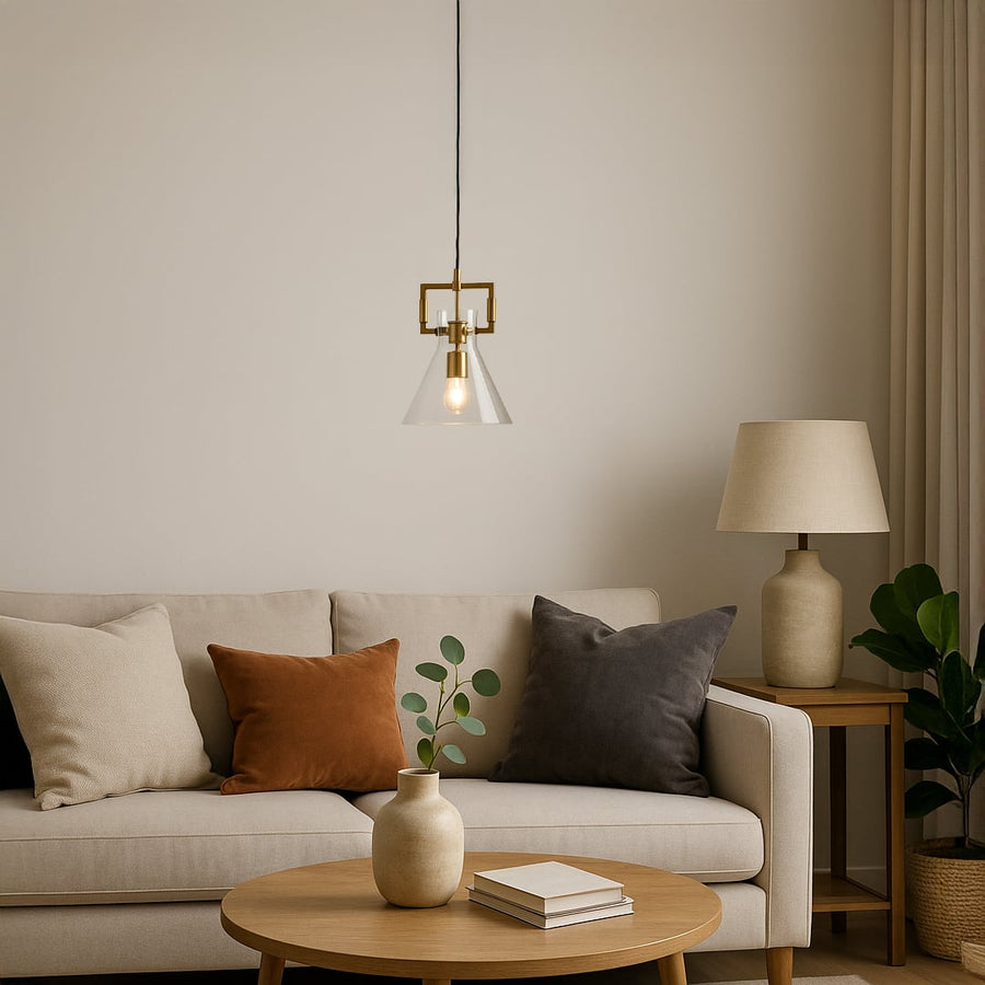 Contemporary cone shaped pendant light displayed with light on adding warm glowing ambience and stylish gold detailing to modern home spaces.