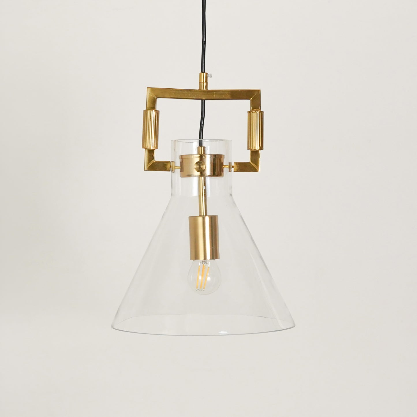 White background image of aspen clear glass hanging pendant lamp with cone shade for elegant dining room decor styling and modern home lighting.