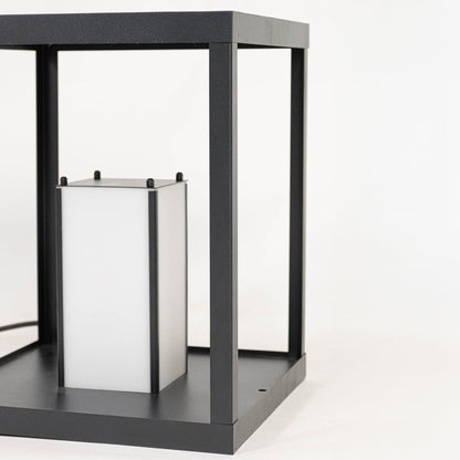 Closeup of modern black metal lantern showing open frame structure clean edges and minimalist decorative lighting design detail.