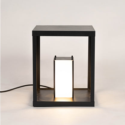 Modern black outdoor wall light with warm glowing panels for stylish exterior decor use.