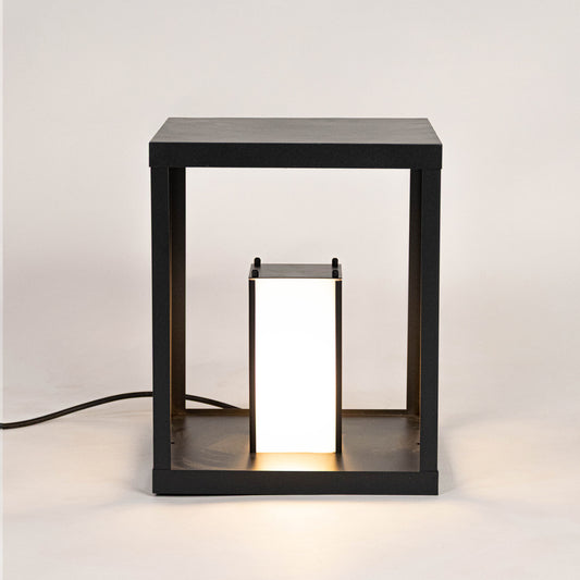 Modern black outdoor wall light with warm glowing panels for stylish exterior decor use.