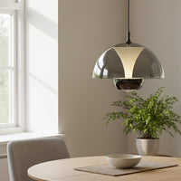 Smoke glass and gold metal pendant light adding contemporary elegance above the dining table.