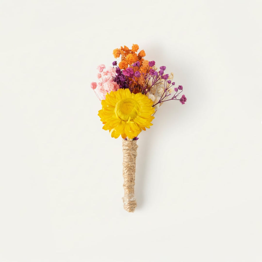 Dried floral stem bouquet with yellow bloom pink purple and orange accents on white background highlighting vibrant color mix handcrafted beauty and decor styling charm.