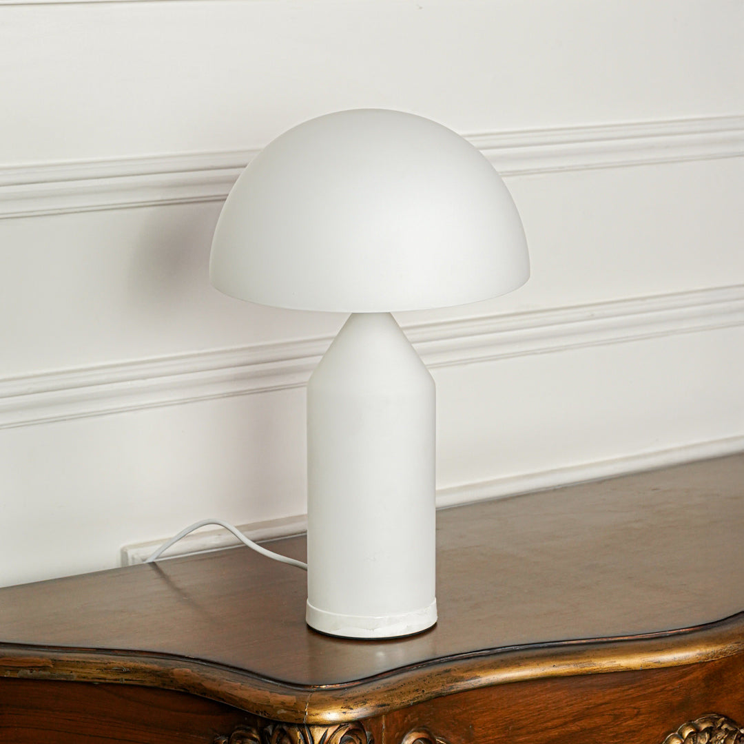 Contemporary white table lamp with mushroom shape design on wooden table ideal for modern bedroom or living room lighting.

