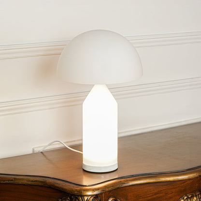 Close view of white table lamp with dome shade and smooth base on neutral background ideal for modern home decor lighting.