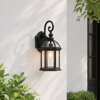 Black metal outdoor wall lantern with curved arm for porch entrance balcony and exterior walls with warm ambient lighting.
