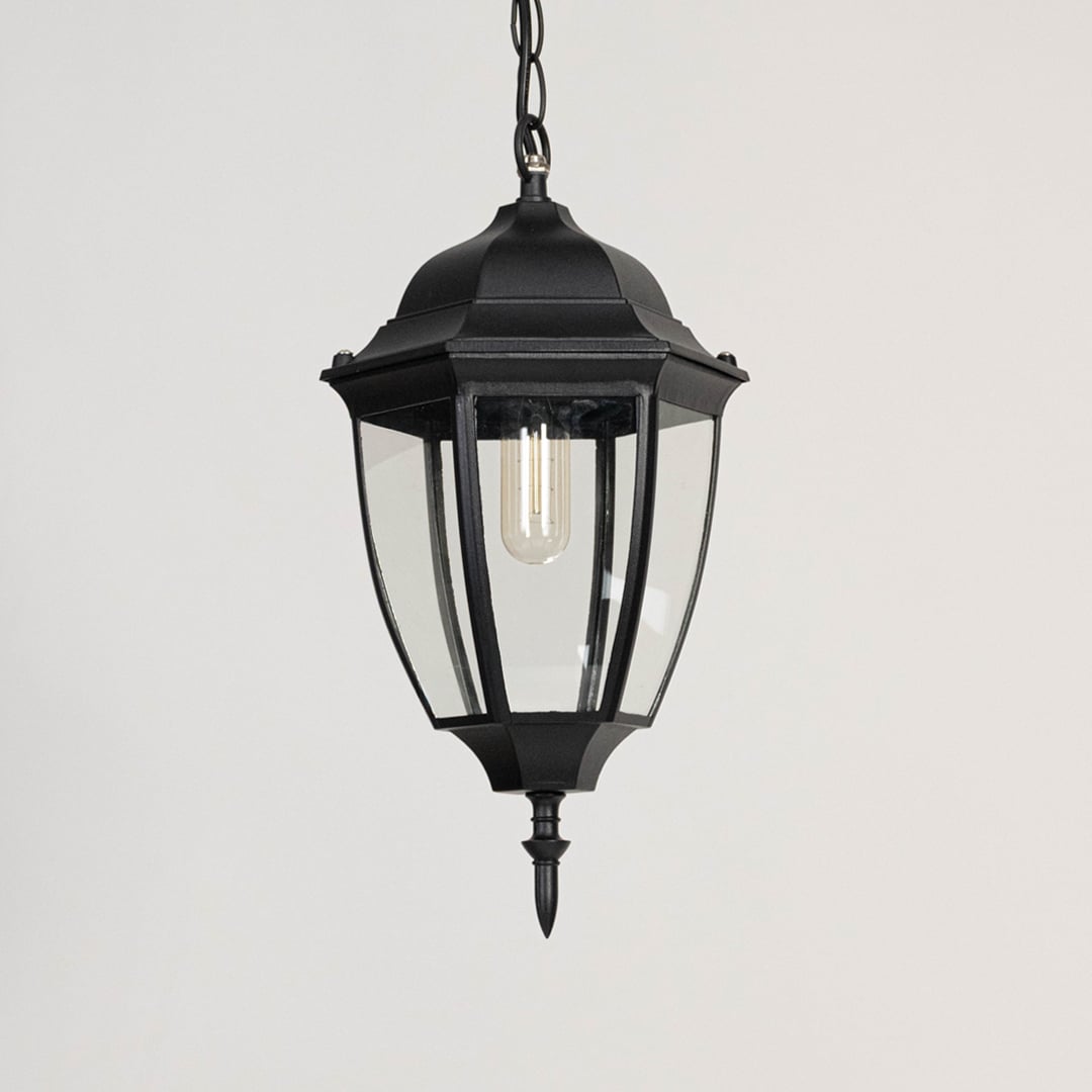 Outdoor hanging lantern light turned off on white background displaying clean glass and matte finish.