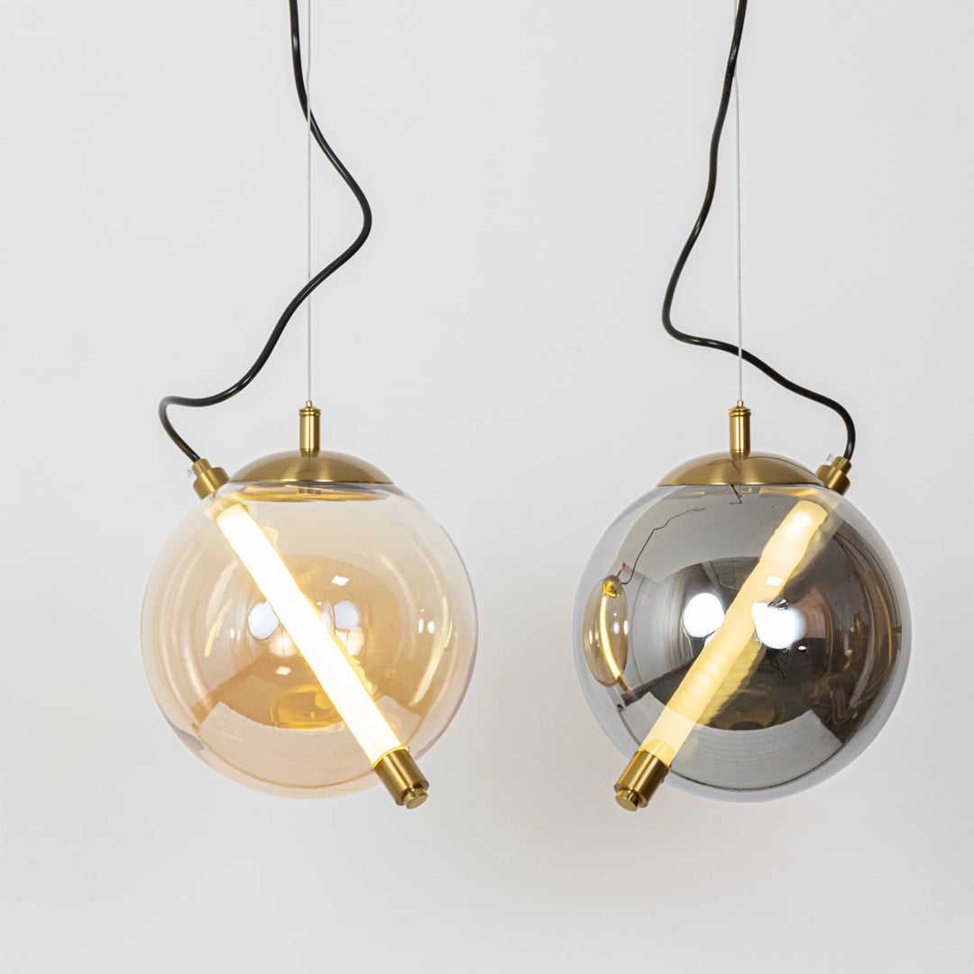 Amber and smoke glass pendant lights with gold metal accents for elegant contemporary home decor.