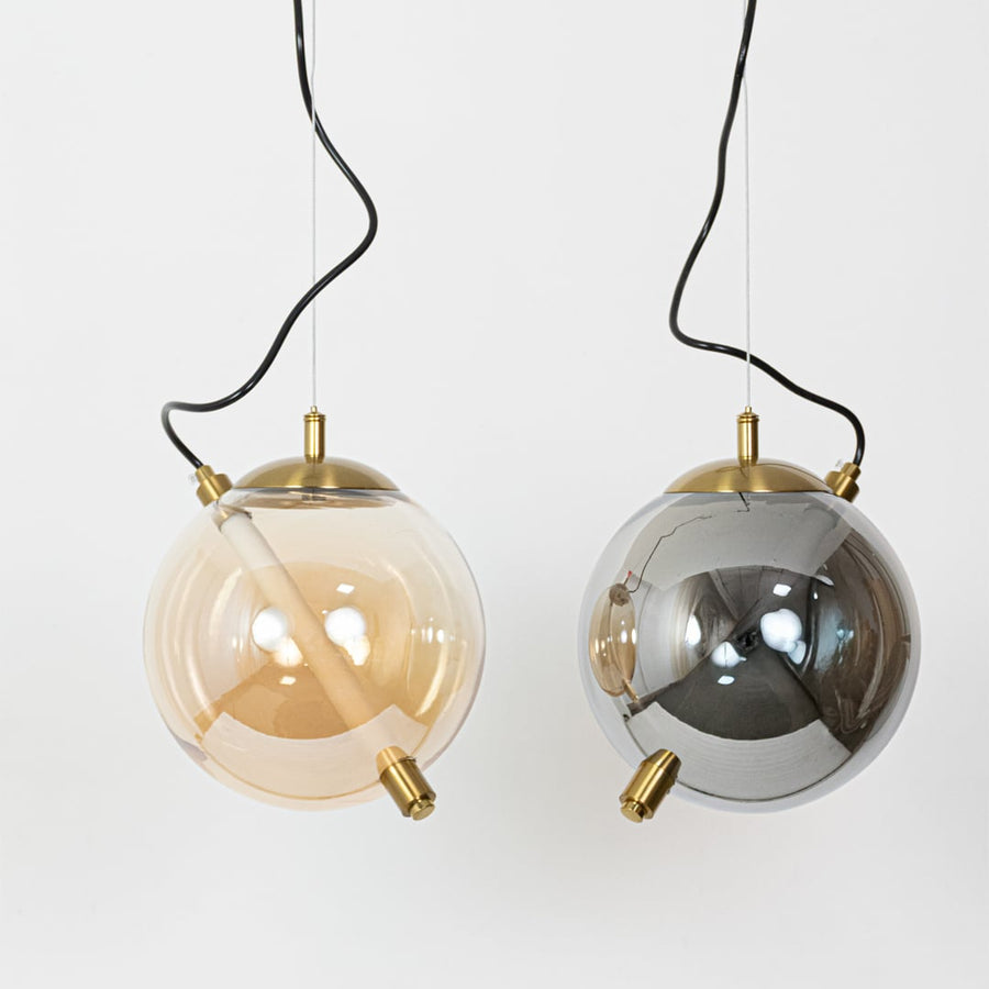 Decorative amber and smoke glass pendant lights showcasing elegant designs for modern home decor.