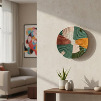 Decorative round wall art with leaf inspired multicolor design mounted above console table adding fresh accent to contemporary living room decor.