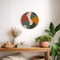 Multicolor decorative wall plate displayed above a console table for artistic contemporary wall decor and home interiors.