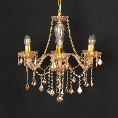 Golden crystal chandelier with ornate detailing shown on black background ideal for premium home ceiling decor.