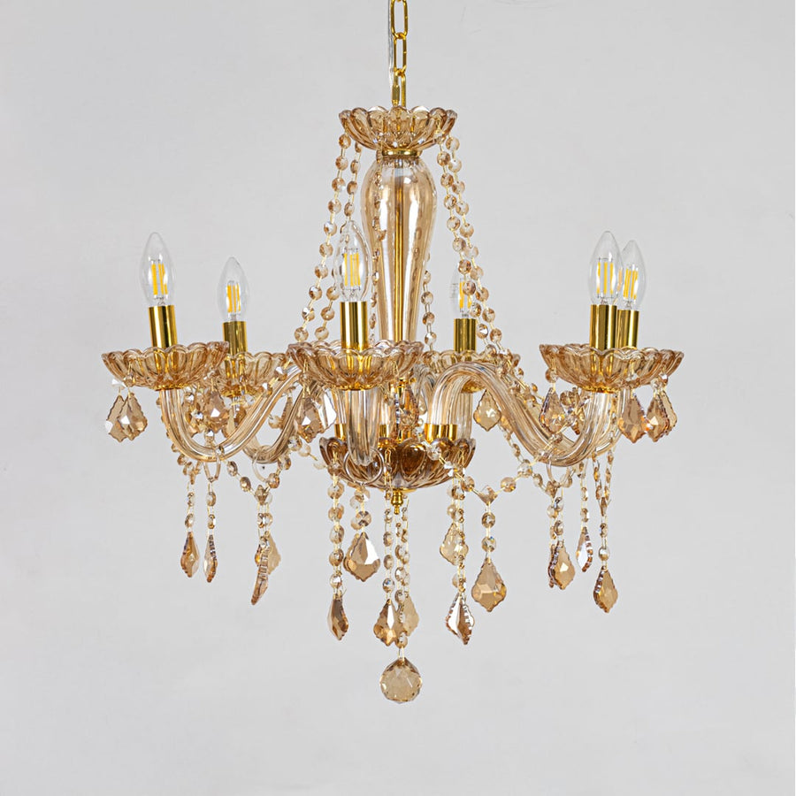 Golden crystal chandelier with decorative beads displayed on white background perfect for classic interior ceilings.
