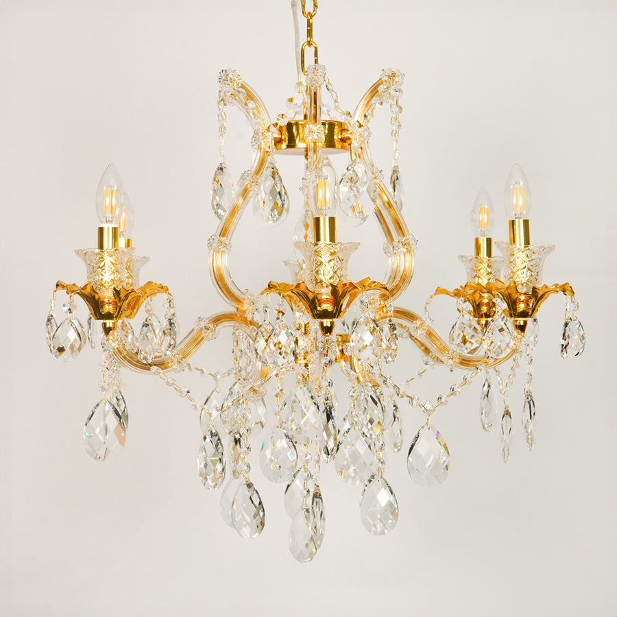 White background image of petite clear crystal chandelier for elegant dining room decor styling with unlit crystal arms.