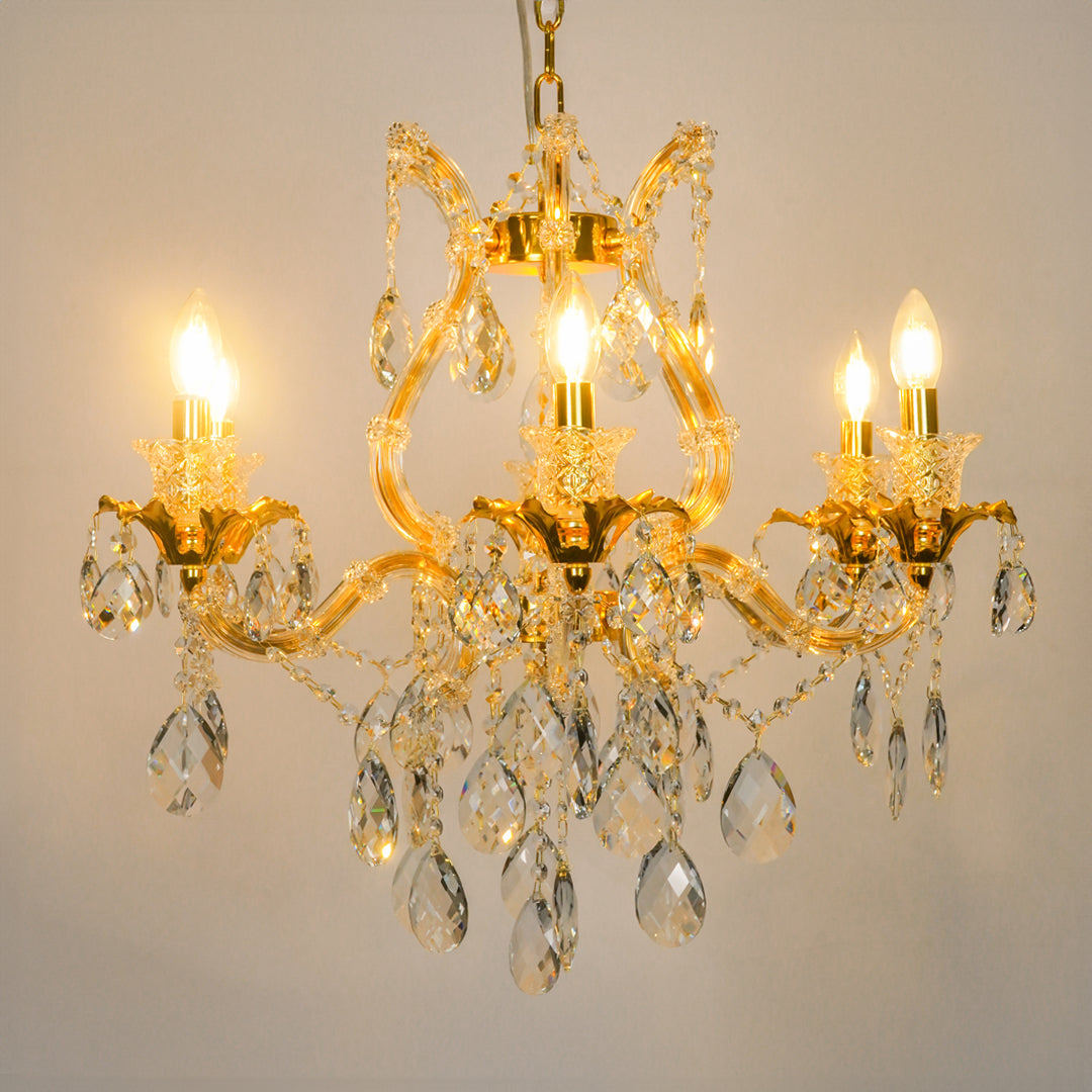 White background image of petite clear crystal chandelier for modern living room decor styling with bright warm lighting.