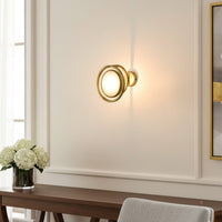 Modern gold ring wall light with warm glow for elegant living room and luxury decor styling spaces.