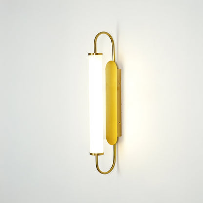 Gold metal wall light on white background with frosted glass shade for elegant minimalist interior decor.