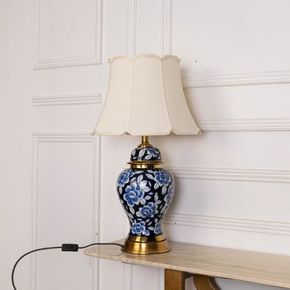 Unlit floral ceramic lamp with gold base and cream shade displays artistic floral detailing perfect as an elegant decor centerpiece.