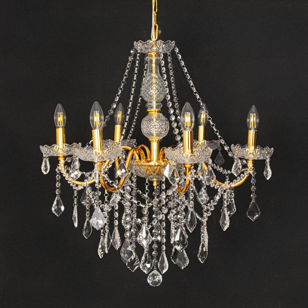 Gold metal crystal chandelier shown on black background highlighting premium crystal detailing for elegant interiors.