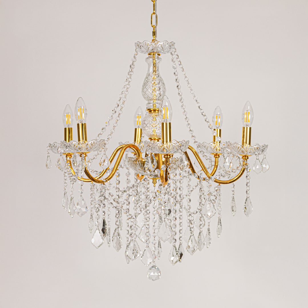 Gold metal crystal chandelier displayed on white background ideal for classic bright interior ceiling styling.