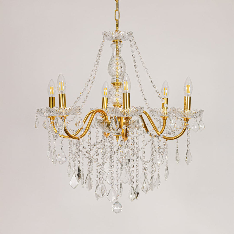 Gold metal crystal chandelier displayed on white background ideal for classic bright interior ceiling styling.