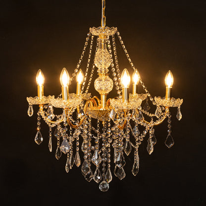 Gold metal crystal chandelier glowing warmly on black background creating a dramatic luxury ceiling feature.