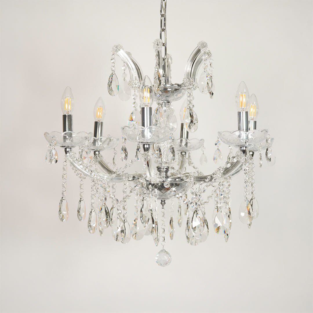 White background image of waterfall crystal chandelier for elegant dining room decor styling with unlit crystal arms.