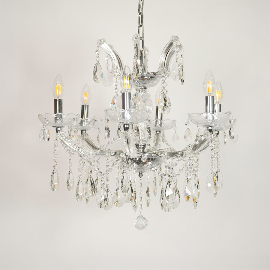 White background image of waterfall crystal chandelier for elegant dining room decor styling with unlit crystal arms.