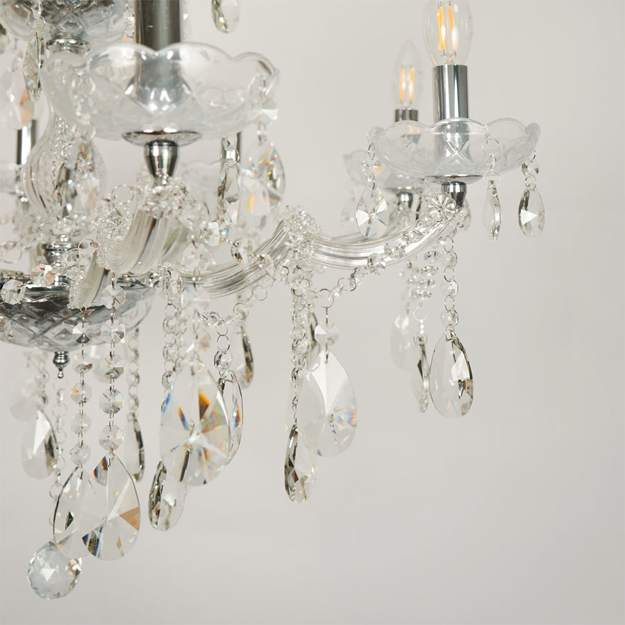 Closeup image of large waterfall crystal chandelier for elegant living room decor styling with beautiful crystal accents.