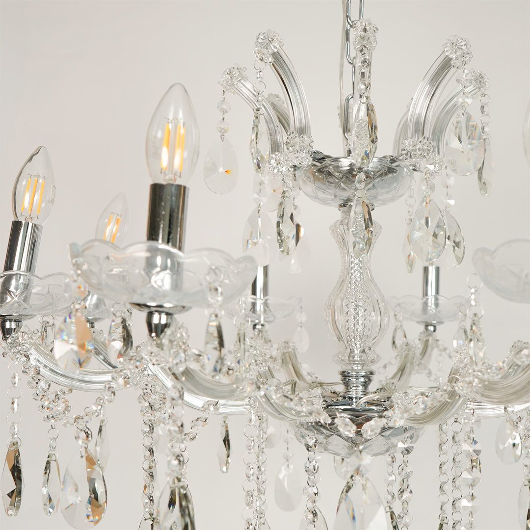 Closeup image of large waterfall crystal chandelier for luxury living room decor styling with polished finish.