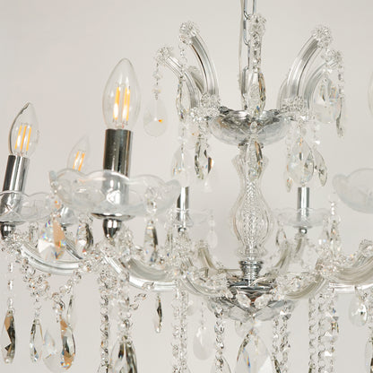 Closeup image of large waterfall crystal chandelier for luxury living room decor styling with polished finish.