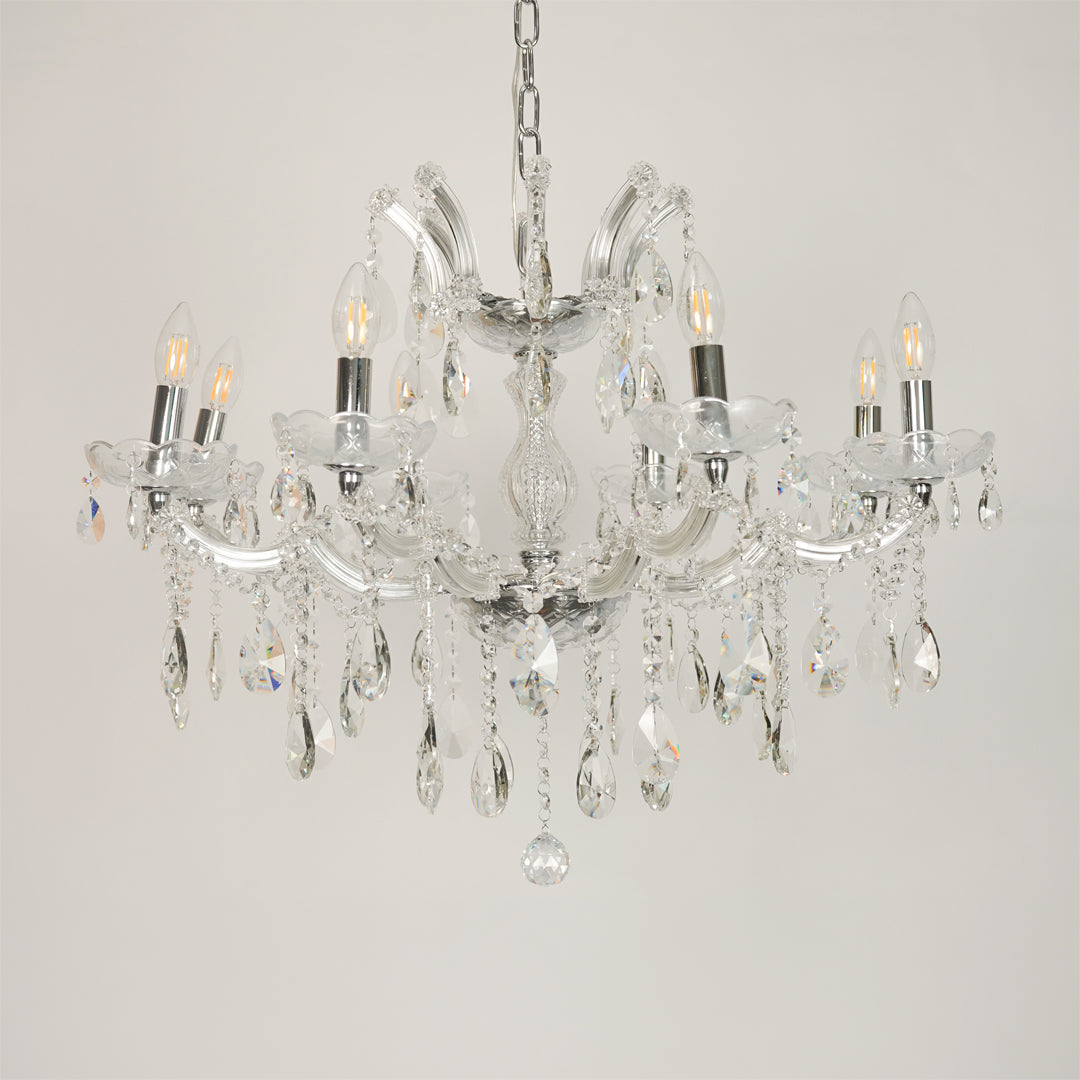 White background image of large waterfall crystal chandelier for elegant dining room decor styling with unlit crystal arms.