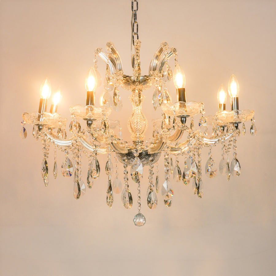 White background image of large waterfall crystal chandelier for modern living room decor styling with a bright warm glow.