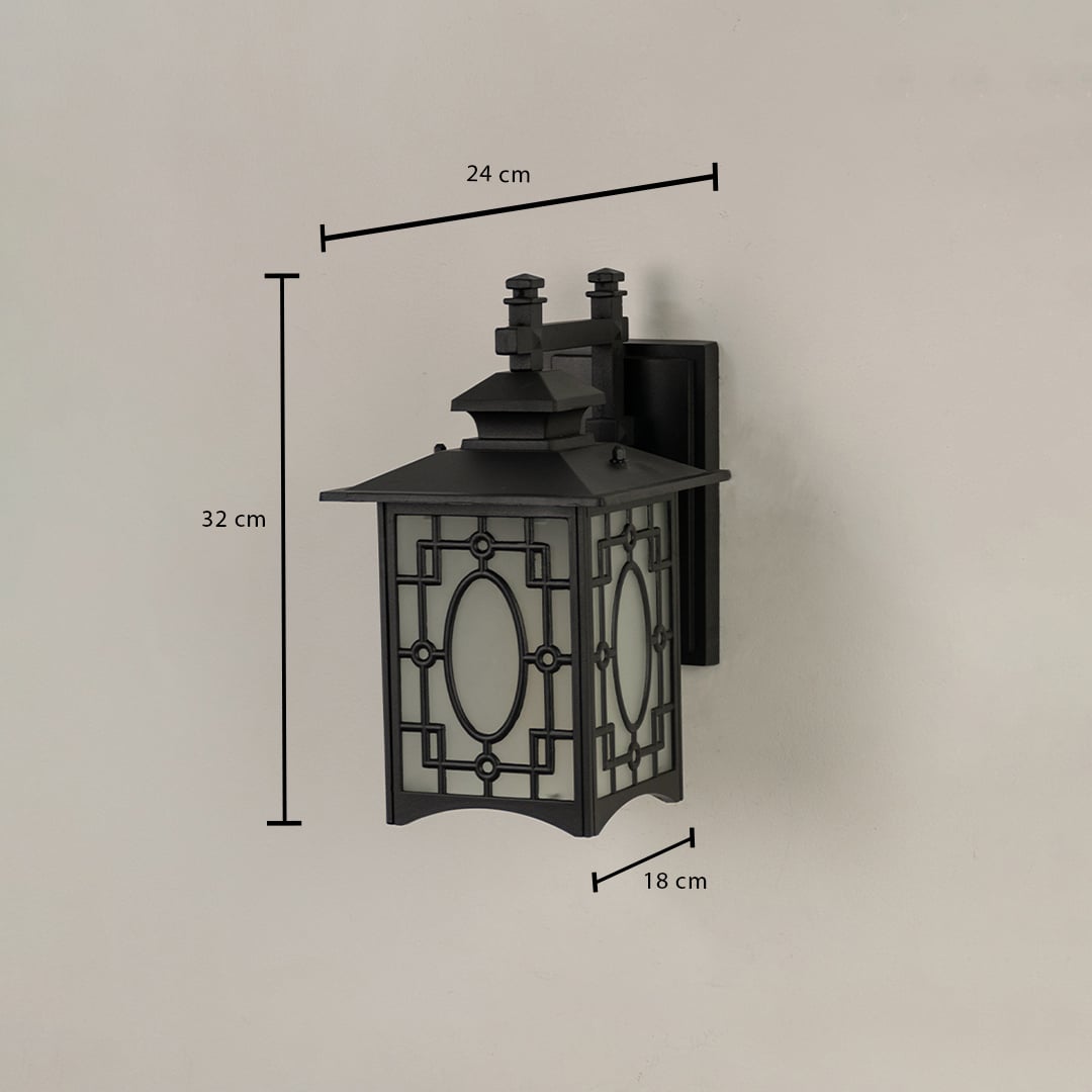 Black metal outdoor lantern with oval patterned frosted glass shown with 32 cm height 24 cm width and 18 cm depth offering accurate exterior installation details.