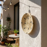 Golden metal wall decor with detailed cutwork pattern displayed in cozy corner creating premium focal point with artistic depth and timeless styling.