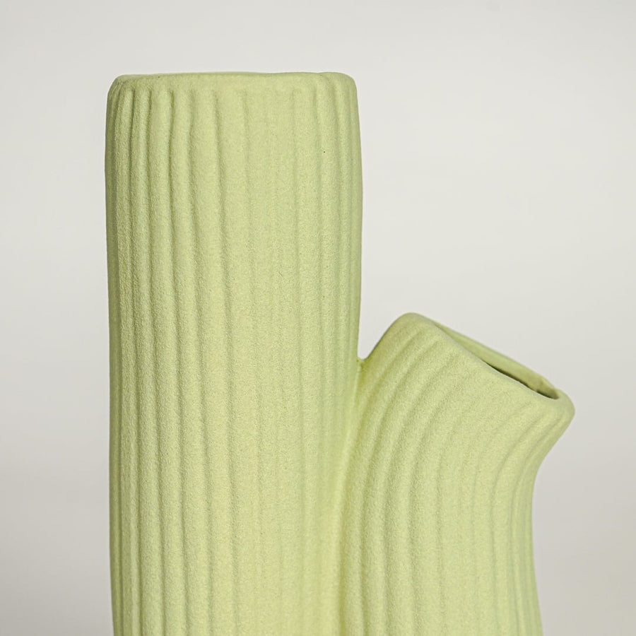 Detailed top view of light green ceramic vase showing twin openings and textured ribbed handmade surface.