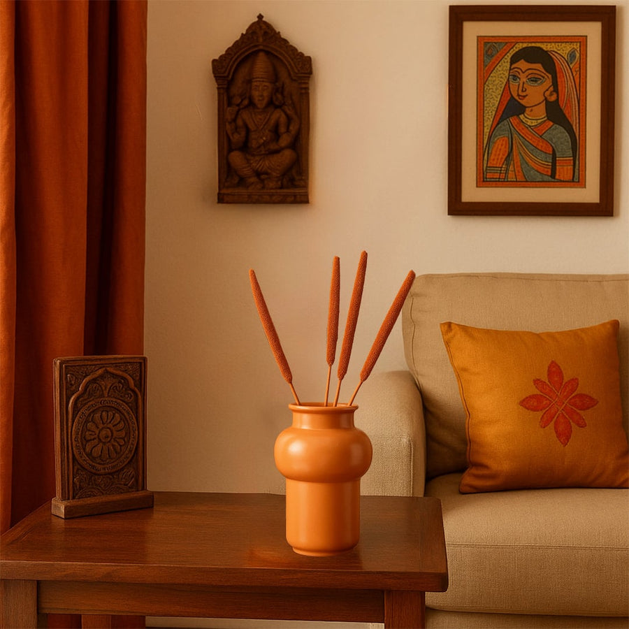 Elegant bulrush stems in a modern white vase styled with artistic decor add natural charm to home interiors.