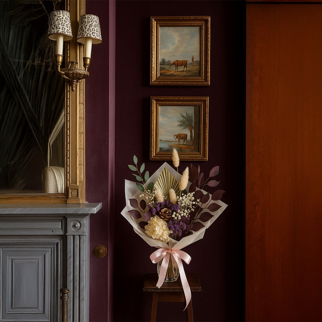 Dried floral arrangement styled in classic interior with framed artwork adding rich color and elegant focal point to home Decor.