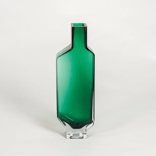 Green decorative art glass vase on white background modern home decor accent piece for table shelf console styling interior.
