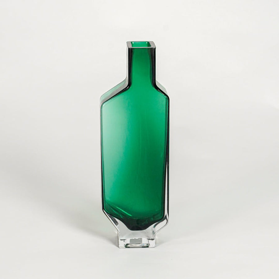 Green decorative art glass vase on white background modern home decor accent piece for table shelf console styling interior.