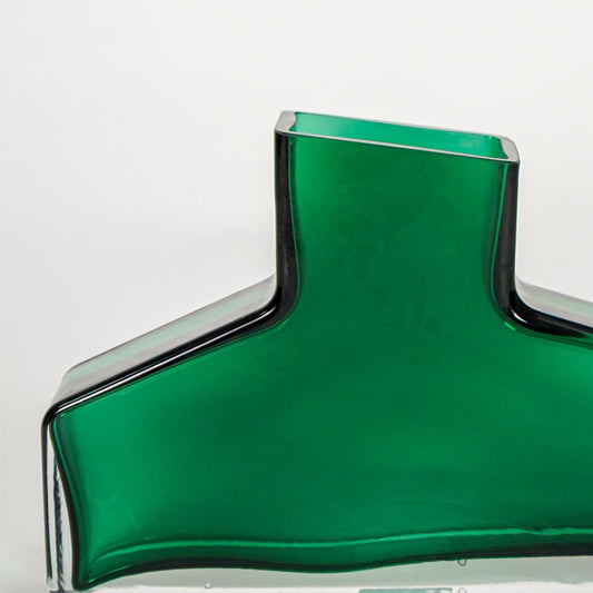 Close up view green art glass vase showing smooth sculpted form glossy finish decorative glass accent for shelf styling home.